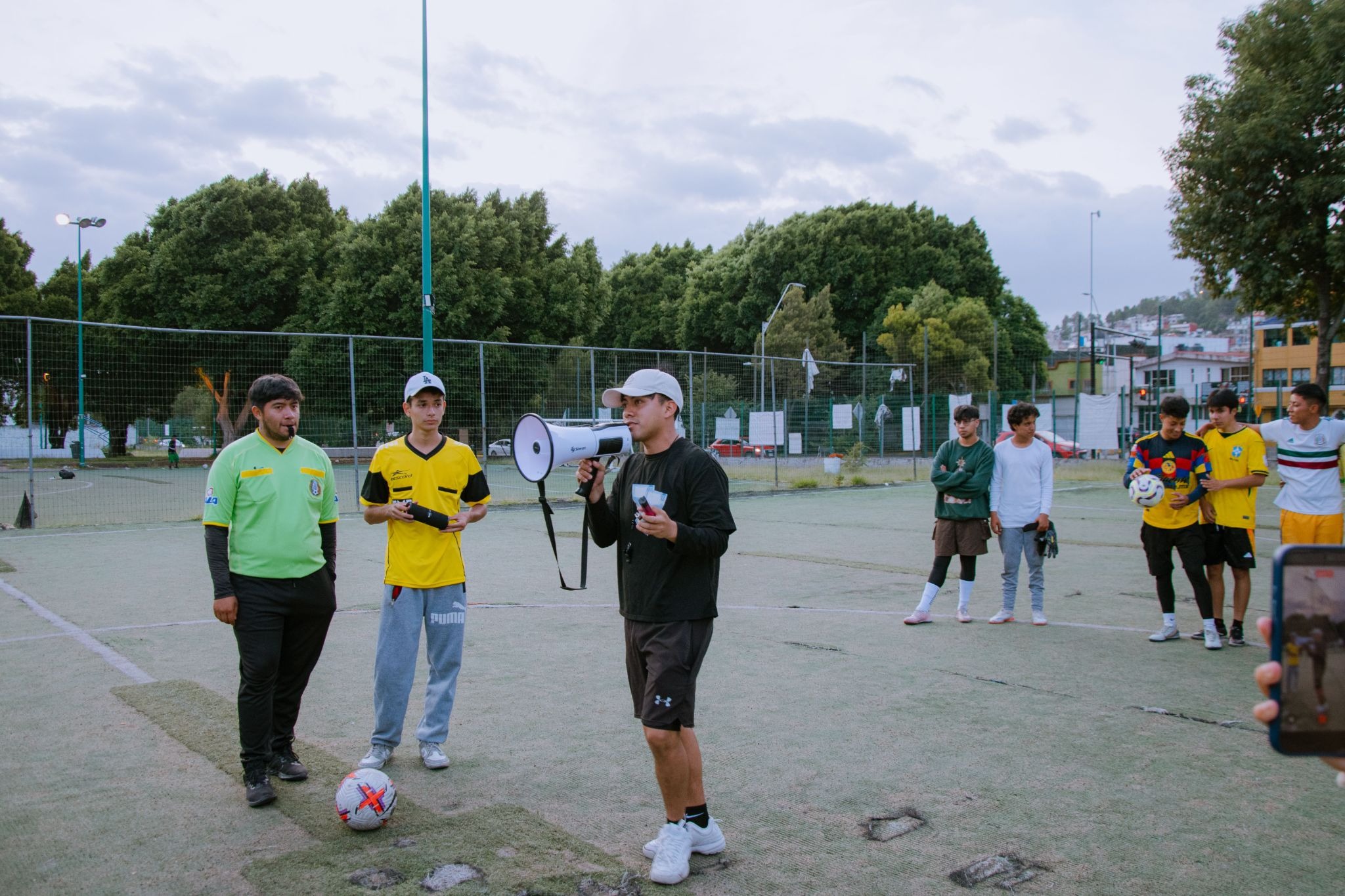 Crianças durante um treino de futebol com orientação do professor.